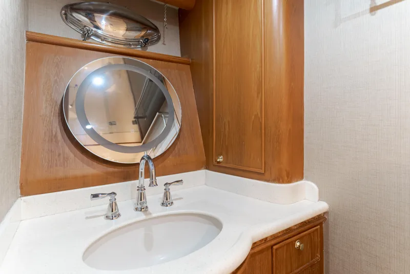 Slide: The Image of Bathroom vanity with round mirror and chrome faucet in 1997 Fobes Cooper Pilthouse. - 25