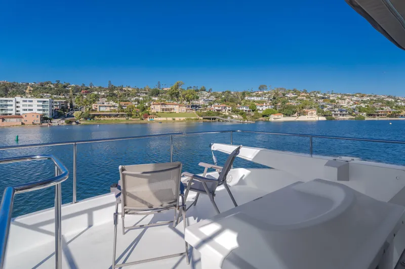 Slide: The Image of Deck view from 1997 Fobes Cooper Pilthouse yacht overlooking serene waterfront and coastal homes. - 31