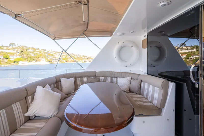 Slide: The Image of Luxurious 1997 Fobes Cooper Pilthouse yacht with elegant outdoor seating and scenic waterfront view. - 32