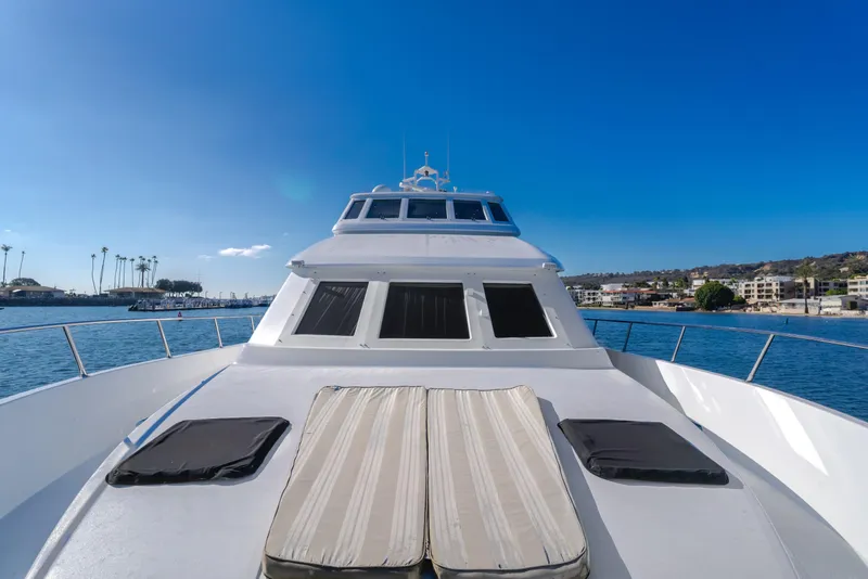 Slide: The Image of 1997 Fobes Cooper Pilthouse yacht on calm water, clear blue sky, coastal view. - 39