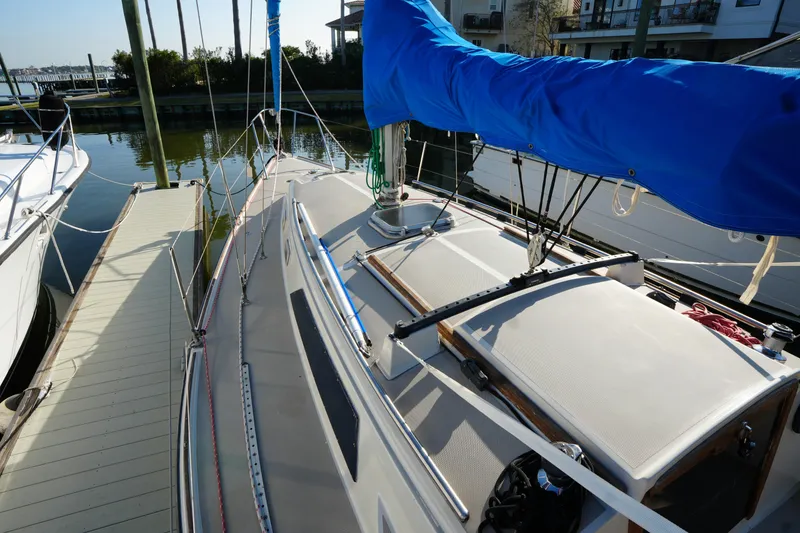 Slide: The Image of 1984 O'Day 30 sailboat docked, featuring blue sail cover and clean deck. - 5