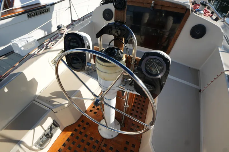 Slide: The Image of 1984 O'Day 30 sailboat cockpit with steering wheel and navigation instruments. - 6