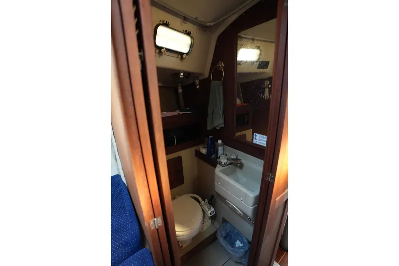 Slide: The Image of 1984 O'Day 30 sailboat bathroom with sink, toilet, and mirror. - 9