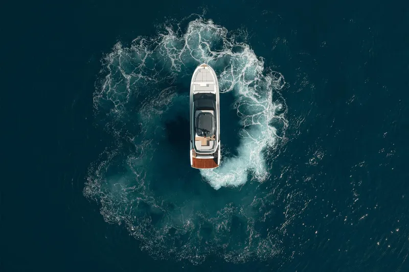 Slide: The Image of Overhead view of 2026 Astondoa AS5 yacht creating circular wake in deep blue sea. - 10