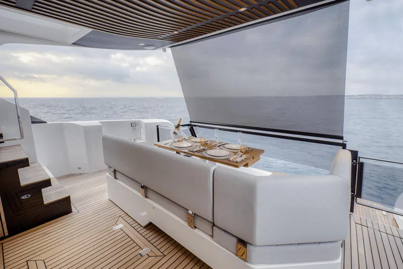 Slide: The Image of Luxurious 2026 Astondoa AS5 yacht deck with elegant dining setup and ocean view. - 12