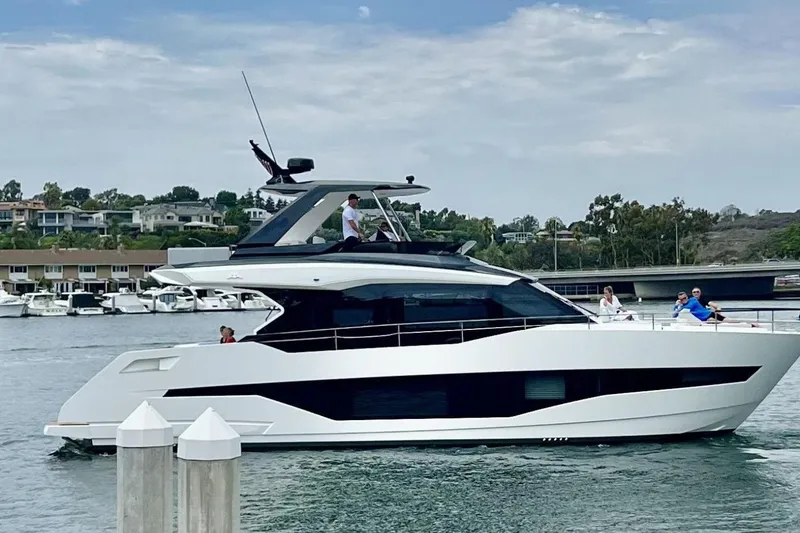 Slide: The Image of 2026 Astondoa AS5 yacht cruising in a scenic marina with passengers on deck. - 4