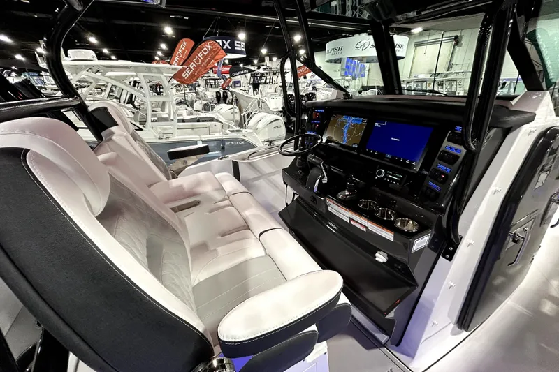 Slide: The Image of 2026 Blackfin 332 CC boat interior with advanced navigation system and luxurious seating. - 12