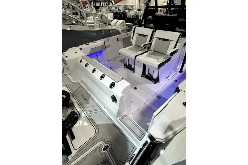 Slide: The Image of 2026 Blackfin 332 CC boat interior with seating and blue LED lighting. - 15