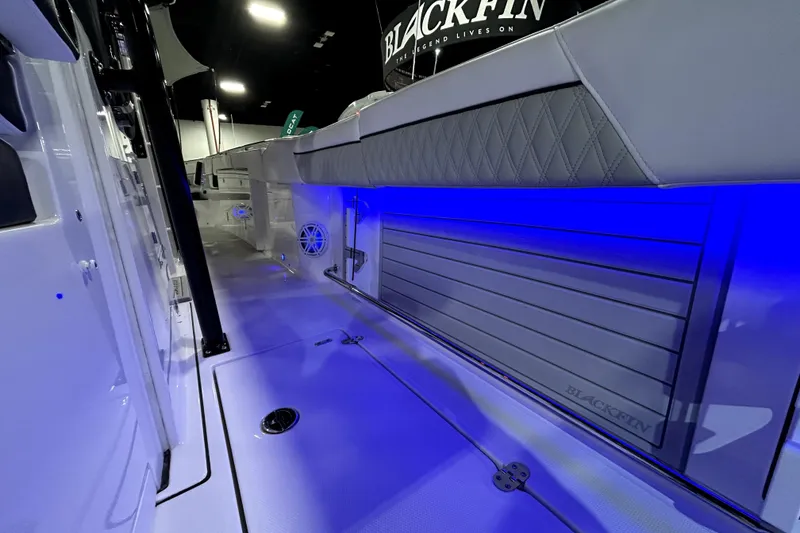 Slide: The Image of 2026 Blackfin 332 CC boat interior with blue LED lighting and sleek design. - 16