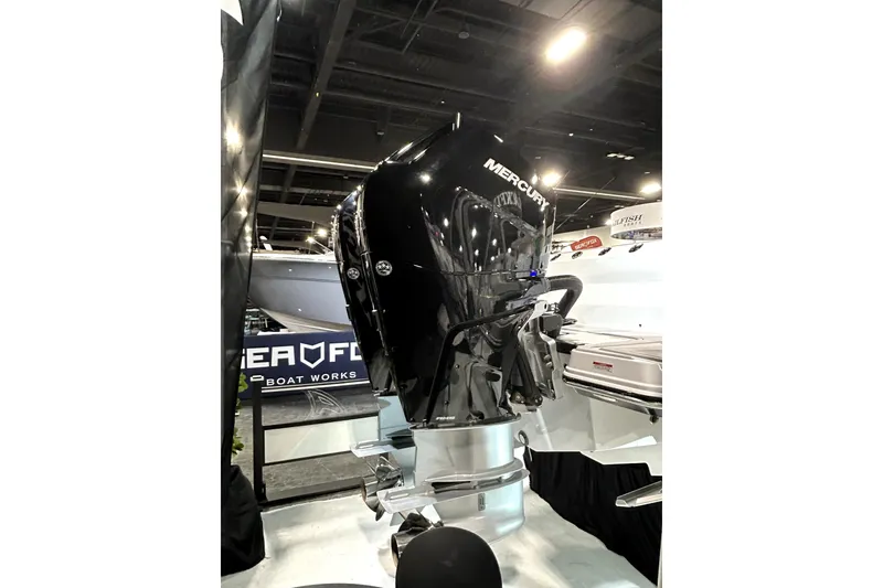 Slide: The Image of 2026 Blackfin 332 CC with Mercury outboard engine at a boat show. - 2