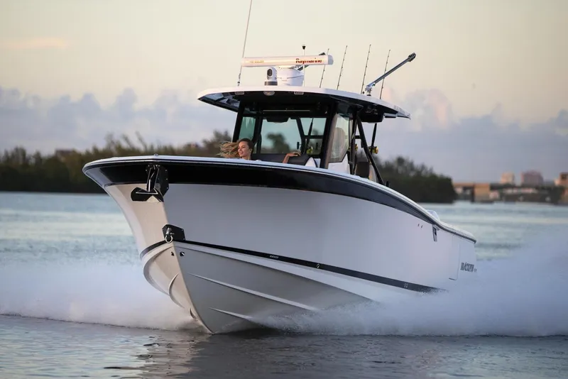 Slide: The Image of Manufacturer Provided Image: 2026 Blackfin 332 CC boat cruising on water at sunset. - 4