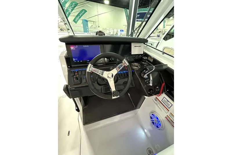 Slide: The Image of 2026 Blackfin 302 DC boat helm with modern controls and steering wheel. - 16