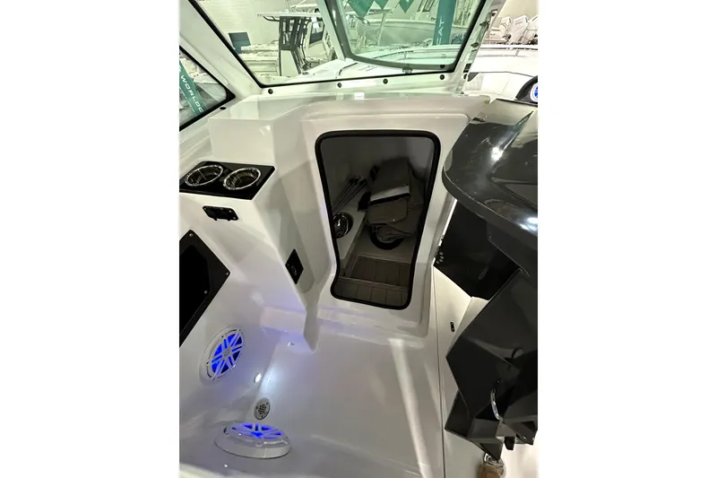 Slide: The Image of 2026 Blackfin 302 DC boat interior with storage compartment and cup holders. - 18