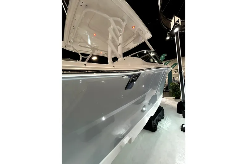 Slide: The Image of 2026 Blackfin 302 DC boat showcased indoors, highlighting sleek design and modern features. - 2