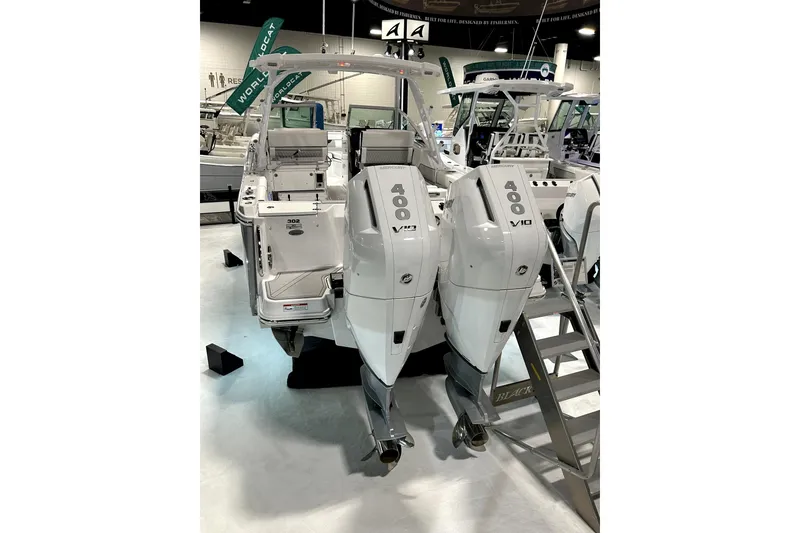 Slide: The Image of 2026 Blackfin 302 DC boat with dual 400 V10 engines displayed indoors. - 3