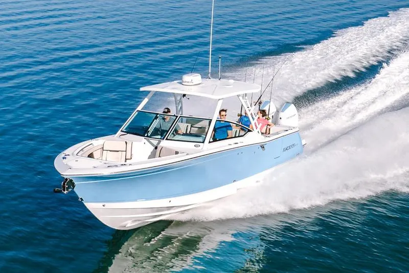Slide: The Image of Manufacturer Provided Image: 2026 Blackfin 302 DC boat cruising on clear blue water. - 4