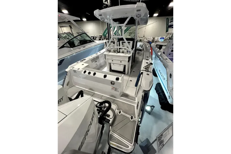 Slide: The Image of 2026 Blackfin 272 CC boat displayed indoors, showcasing sleek design and modern features. - 12