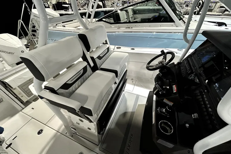 Slide: The Image of 2026 Blackfin 272 CC boat interior with dual seats and steering console. - 16