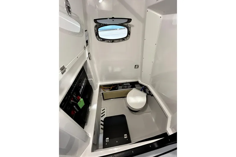 Slide: The Image of 2026 Blackfin 272 CC boat interior with compact bathroom and window. - 19