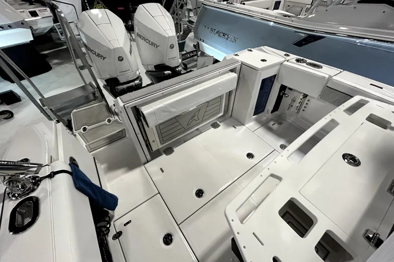 Slide: The Image of 2026 Blackfin 272 CC boat interior with dual Mercury engines, showcasing spacious deck layout. - 20