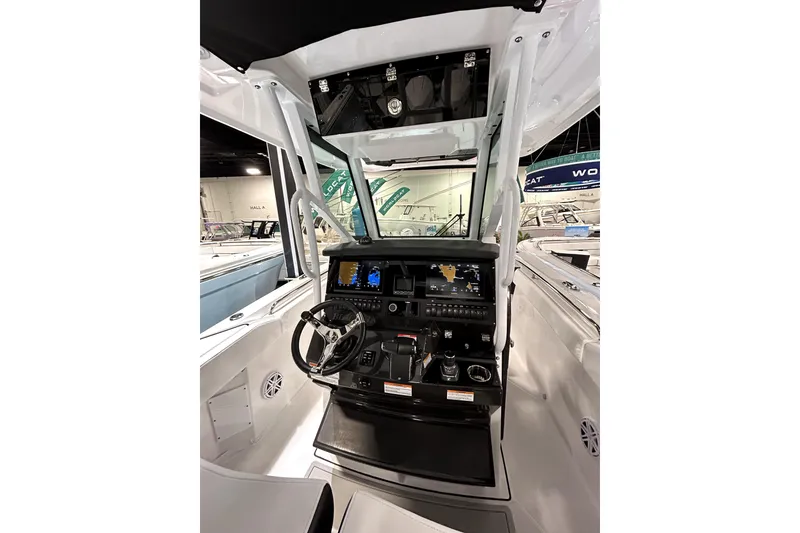 Slide: The Image of 2026 Blackfin 272 CC boat cockpit with advanced navigation system and steering wheel. - 22