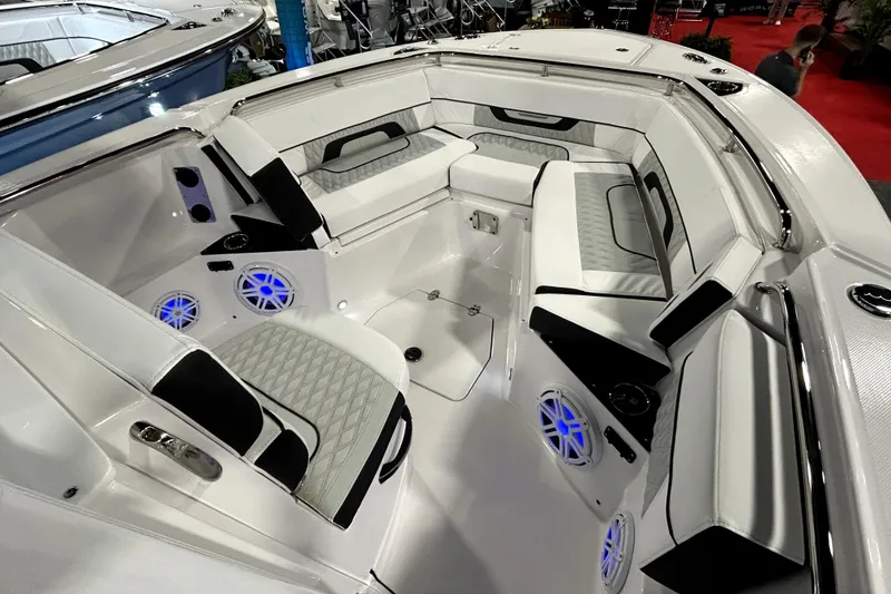 Slide: The Image of 2026 Blackfin 252 CC boat interior with white seating and blue LED speakers. - 10