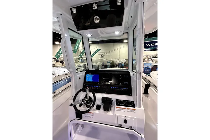 Slide: The Image of 2026 Blackfin 252 CC boat cockpit with modern navigation system and steering wheel. - 12
