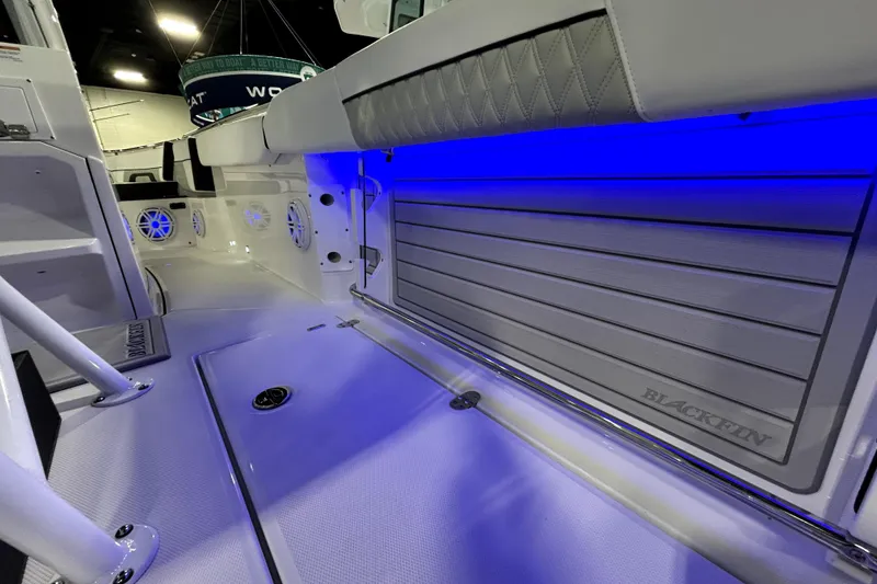 Slide: The Image of 2026 Blackfin 252 CC boat interior with blue LED lighting and sleek design. - 14