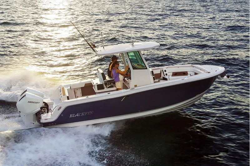 Slide: The Image of Manufacturer Provided Image: 2026 Blackfin 252 CC boat cruising on open water at sunset. - 2