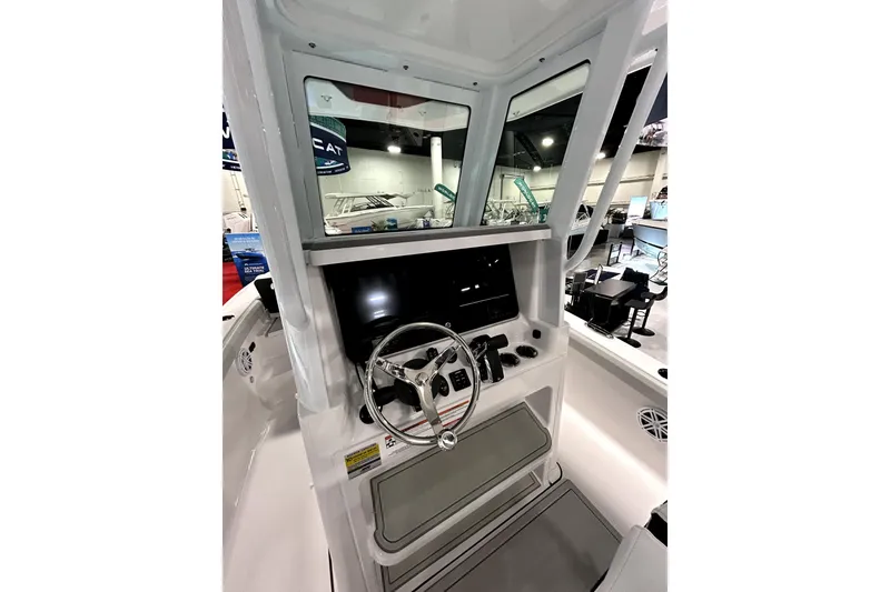 Slide: The Image of 2026 Blackfin 242 HB boat helm with steering wheel and control panel. - 13