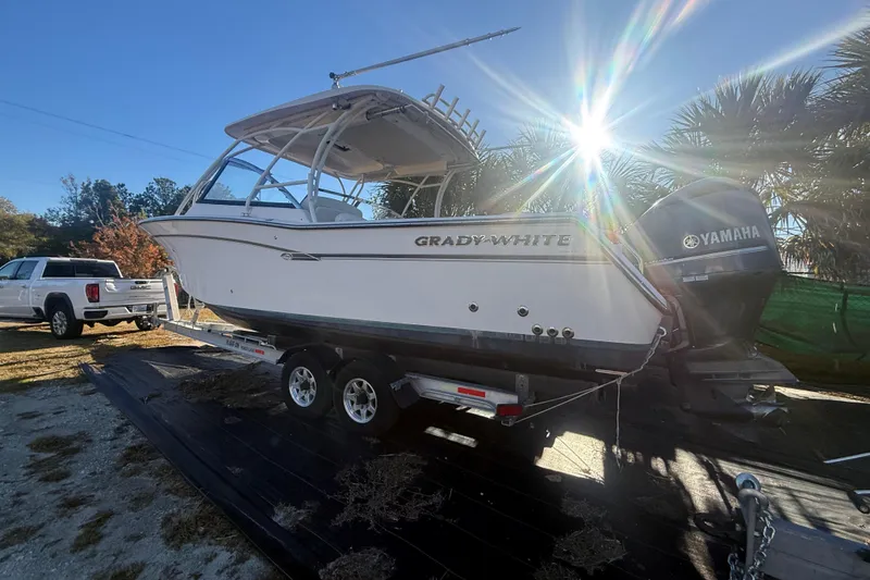 Slide: The Image of 2015 Grady-White Freedom 307 boat on trailer, sunlit, with Yamaha engine. - 1