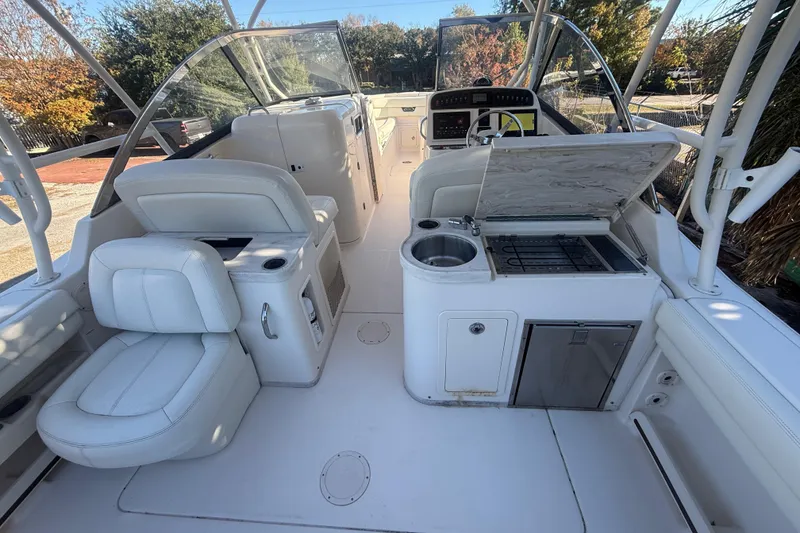 Slide: The Image of 2015 Grady-White Freedom 307 boat interior with seating and kitchenette. - 11
