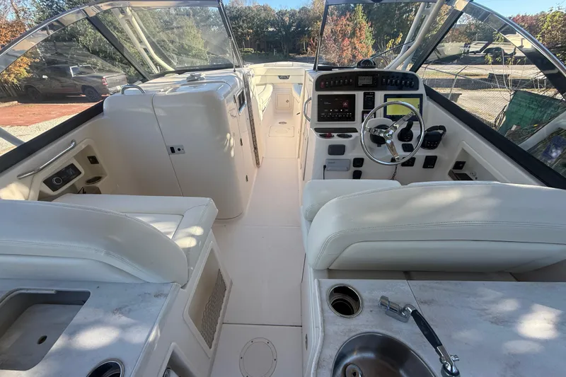 Slide: The Image of 2015 Grady-White Freedom 307 boat interior with steering wheel and seating. - 13
