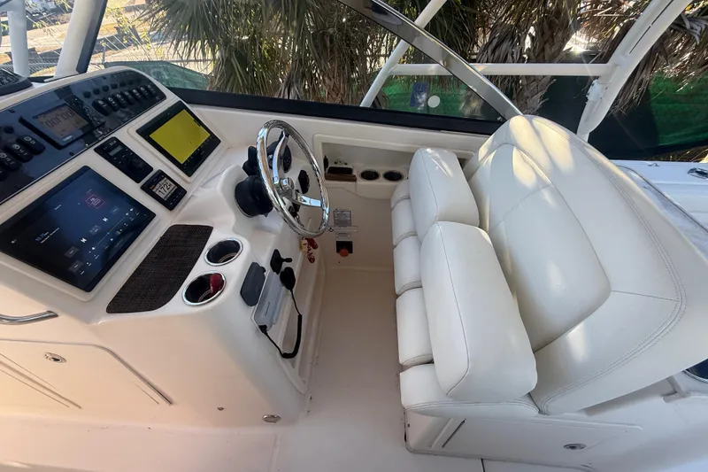 Slide: The Image of 2015 Grady-White Freedom 307 boat cockpit with steering wheel and control panel. - 16