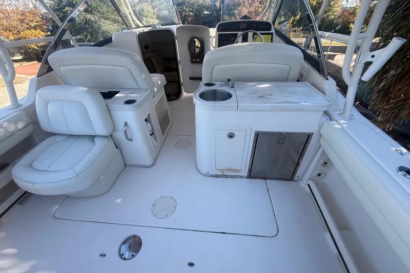 Slide: The Image of 2015 Grady-White Freedom 307 boat interior with seating and kitchenette area. - 18