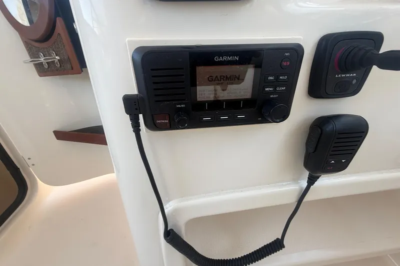 Slide: The Image of Garmin marine radio on 2015 Grady-White Freedom 307 boat dashboard. - 19