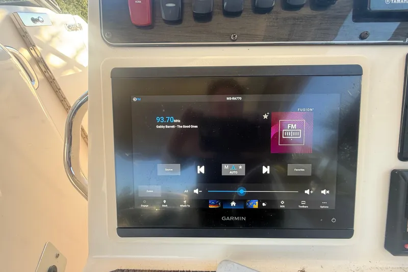 Slide: The Image of Garmin display on 2015 Grady-White Freedom 307 boat, showing FM radio interface. - 21