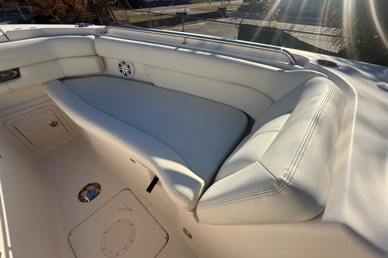 Slide: The Image of 2015 Grady-White Freedom 307 boat interior with white cushioned seating. - 25