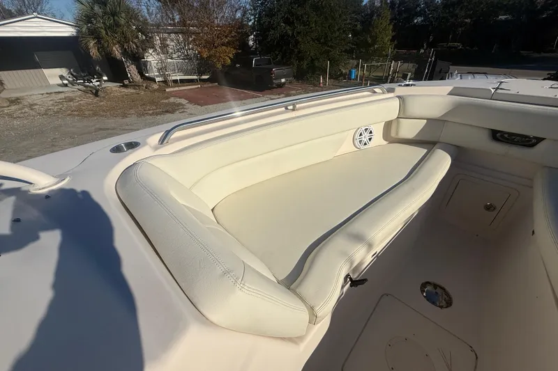 Slide: The Image of 2015 Grady-White Freedom 307 boat interior with cushioned seating and speaker. - 26