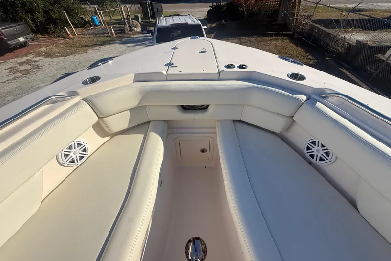 Slide: The Image of 2015 Grady-White Freedom 307 boat interior with cushioned seating and speakers. - 27