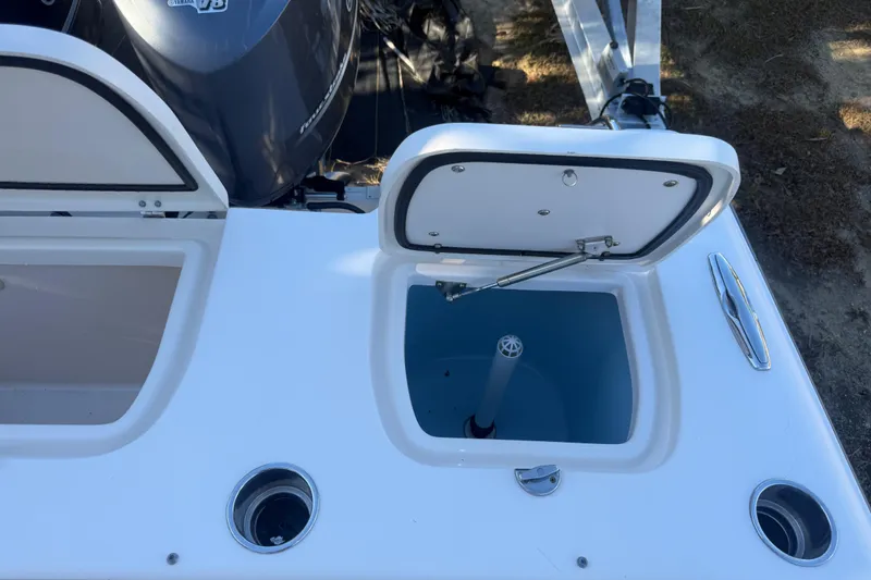 Slide: The Image of 2015 Grady-White Freedom 307 boat with open storage compartment and Yamaha V8 engine. - 28