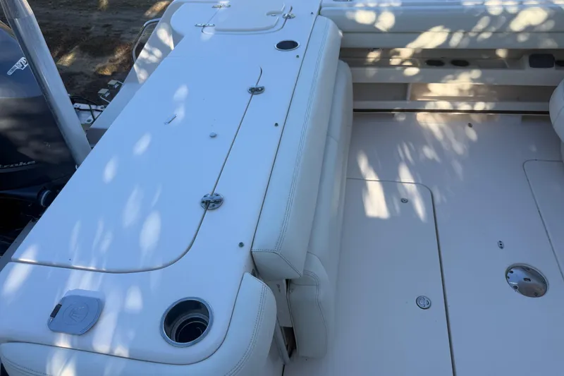 Slide: The Image of 2015 Grady-White Freedom 307 boat interior with seating and storage compartments. - 30