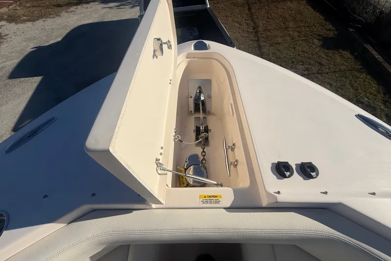 Slide: The Image of 2015 Grady-White Freedom 307 boat anchor compartment, open lid, sunny day. - 32
