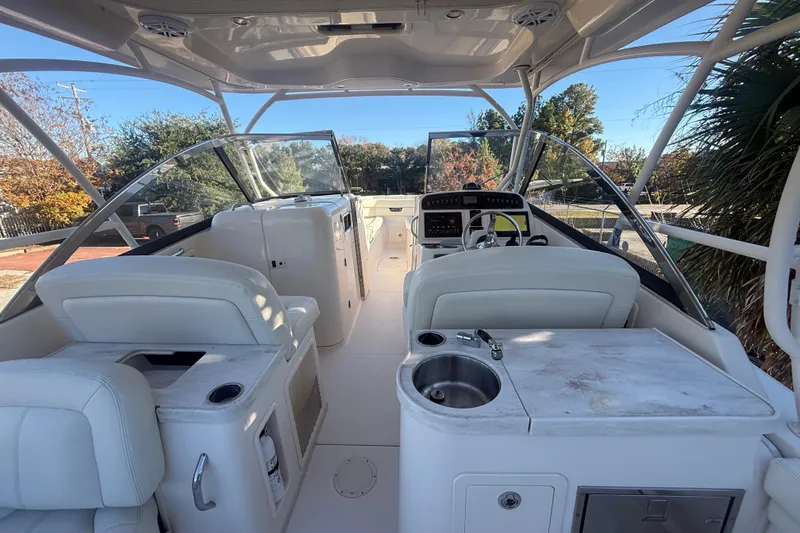 Slide: The Image of 2015 Grady-White Freedom 307 boat interior with helm, seating, and sink. - 35