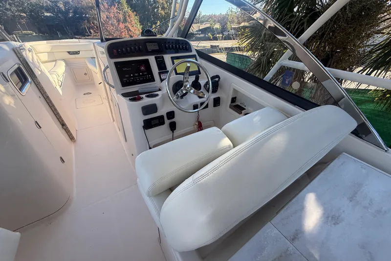 Slide: The Image of 2015 Grady-White Freedom 307 boat interior with steering wheel and control panel. - 37