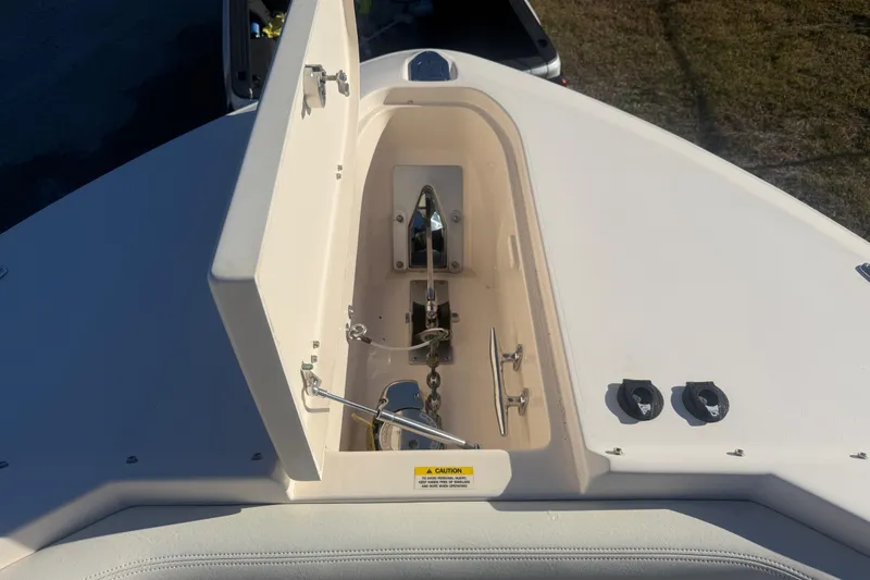 Slide: The Image of 2015 Grady-White Freedom 307 boat anchor compartment, open lid, sunny day. - 8