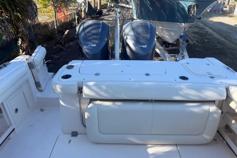 Slide: The Image of 2015 Grady-White Freedom 307 boat with dual outboard engines, docked outdoors. - 9