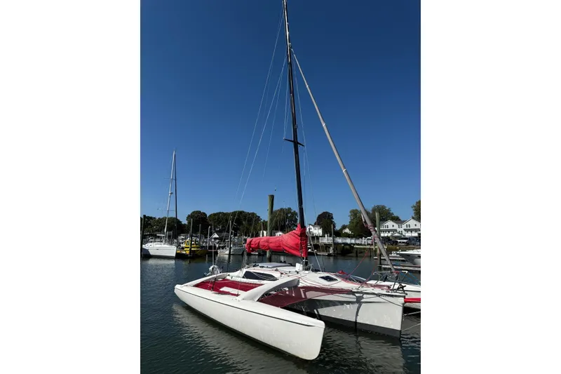 Slide: The Image of Sailboat Corsair F-28R #57, 1998 model, docked in a marina under clear blue sky. - 4