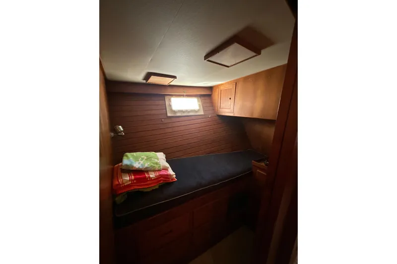 Slide: The Image of 1985 Kong & Halvorsen Island Gypsy cabin interior with wooden paneling and single bed. - 10
