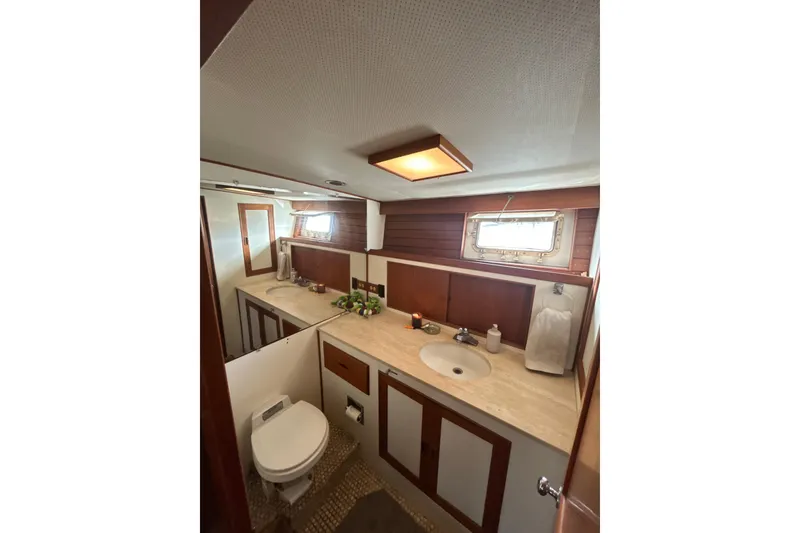 Slide: The Image of 1985 Kong & Halvorsen Island Gypsy yacht bathroom with wooden cabinetry and modern fixtures. - 2